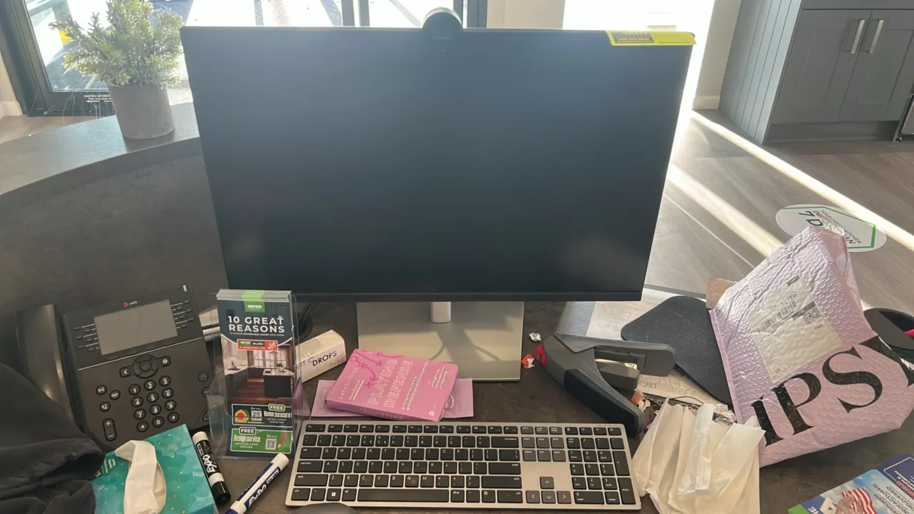 Dell 27" flatscreen monitor. Includes wireless keyboard and multi-device wireless mouse. Features an integrated top-mounted webcam and an adjustable d