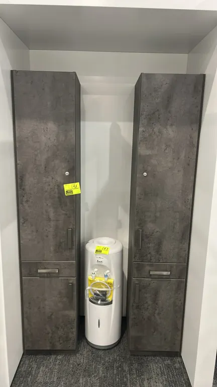 Laminate standing storage cabinets. Features textured gray finish, upper locking door with interior shelf and hooks, center drawer, lower storage cabi