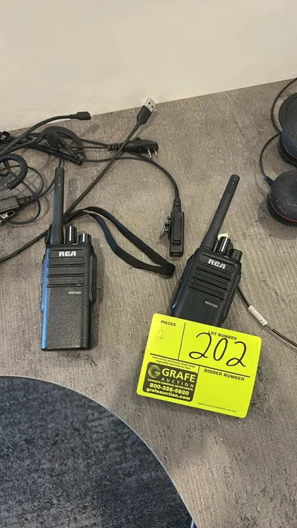 RCA RDR1520 two-way radios. Includes (2) handheld radios, earpiece headsets, and USB charging cables.