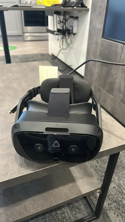 HTC Vive Focus Vision mixed reality and PC VR headset. Features front tracking and color pass-through cameras, adjustable rigid head strap with rear a