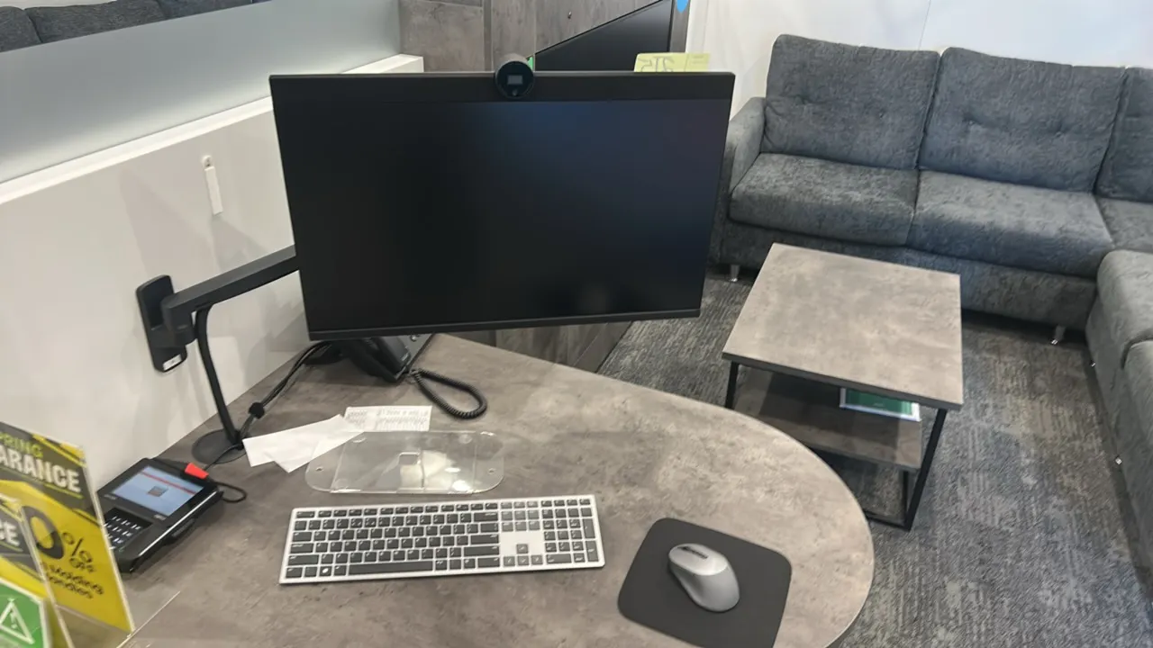 Dell P2724DEB 27" flat panel monitors. Features integrated pop-up webcams. Includes keyboards, computer mice, and articulating mounting arms. Electric