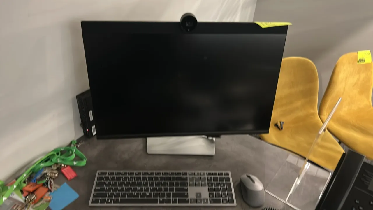 Dell P2724DEB 27" flat panel monitor. Features integrated top webcam. Includes adjustable desktop stand, keyboard, and mouse. Electrical: 240V. Backgr
