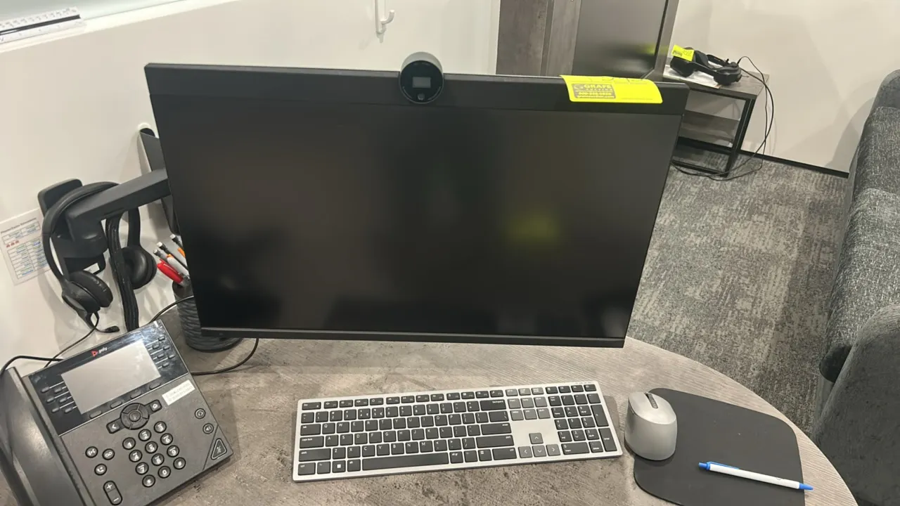 Dell P2724DEB 27" flat panel monitor. Features integrated webcam. Includes keyboard and mouse. Electrical: 240V. Mounted on an articulating arm. Desk,