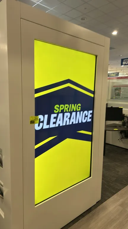 75" flatscreen display monitor. Features portrait orientation and an integrated white freestanding kiosk enclosure.