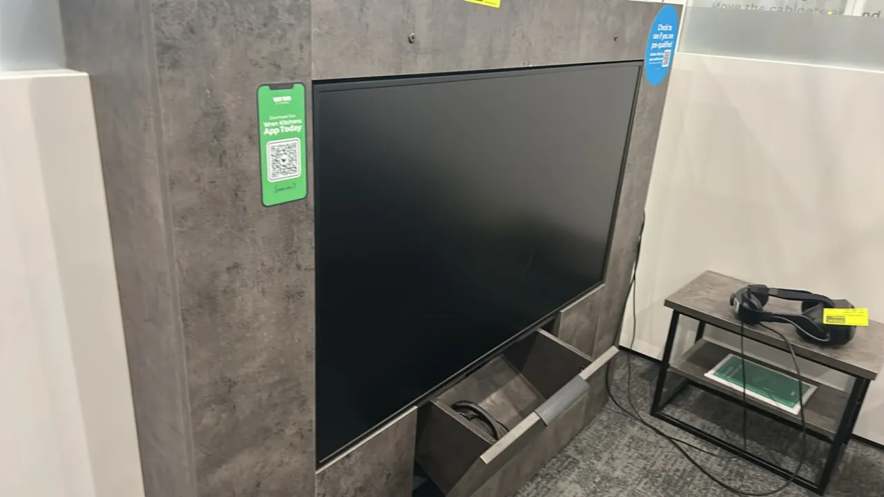 49" flatscreen built-in display monitor. Integrated into a gray textured laminate enclosure featuring a lower pull-out storage compartment. Includes c