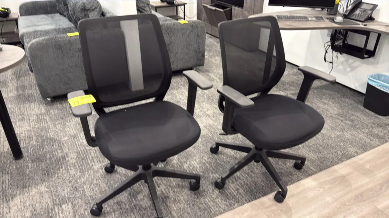 Rolling mesh-back office chairs. Features breathable black mesh backrest, contoured black fabric upholstered seat, and fixed T-style armrests. Mounted