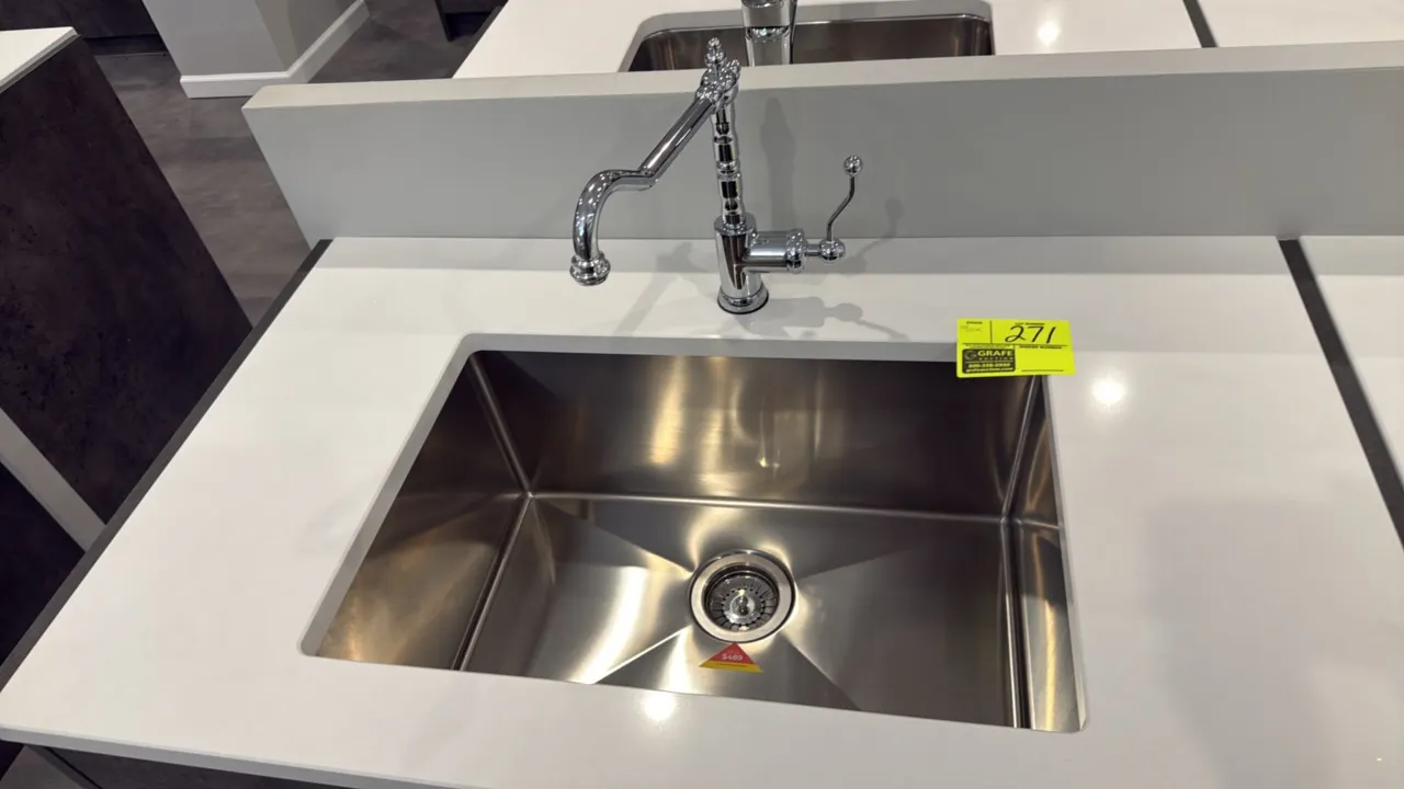 Single-bowl undermount sink. Features stainless steel construction, channeled basin, and drain basket assembly. Includes chrome finish faucet. 26". Co