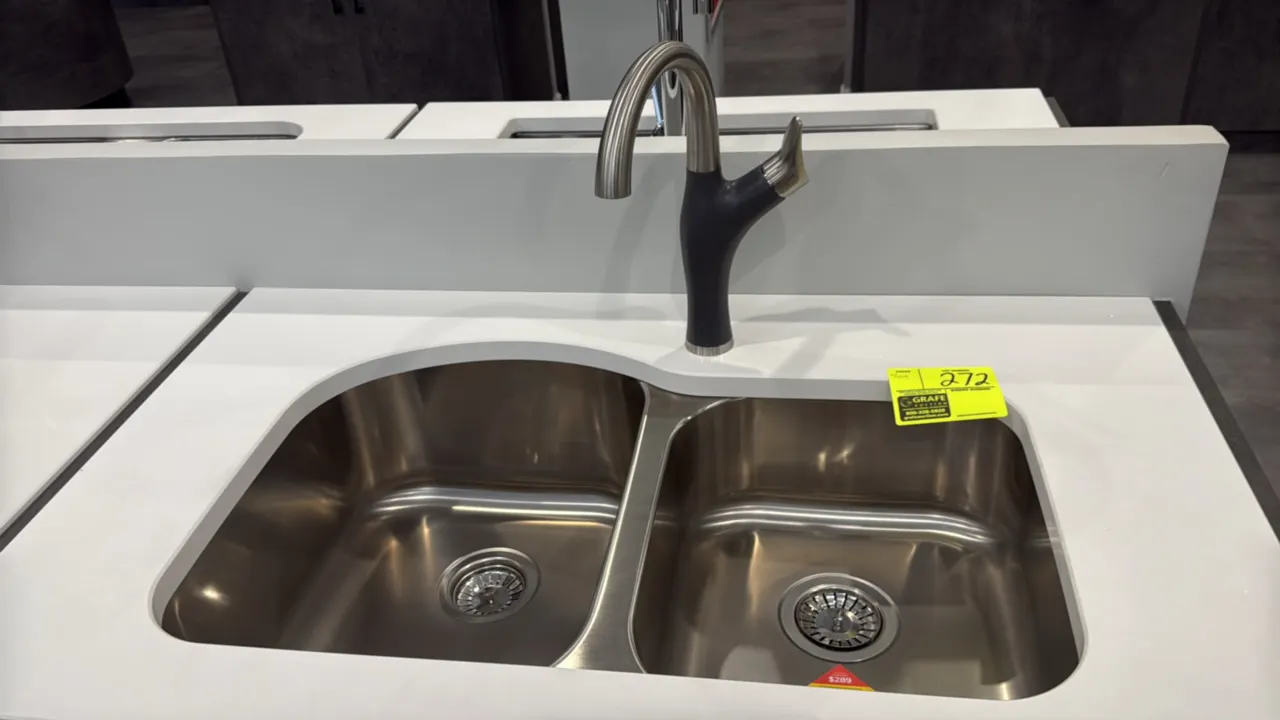 Stainless steel 2-bowl undermount sink. Features 60/40 split basin configuration, basket strainers, and a two-tone single-handle pull-down faucet. 31"