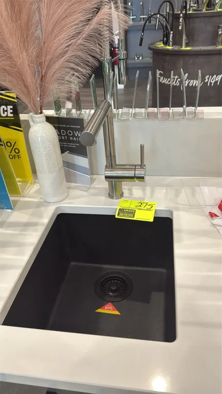 16" single-bowl dual-mount composite sink in metallic black finish. Includes stainless steel pull-out single-handle faucet and matching drain assembly