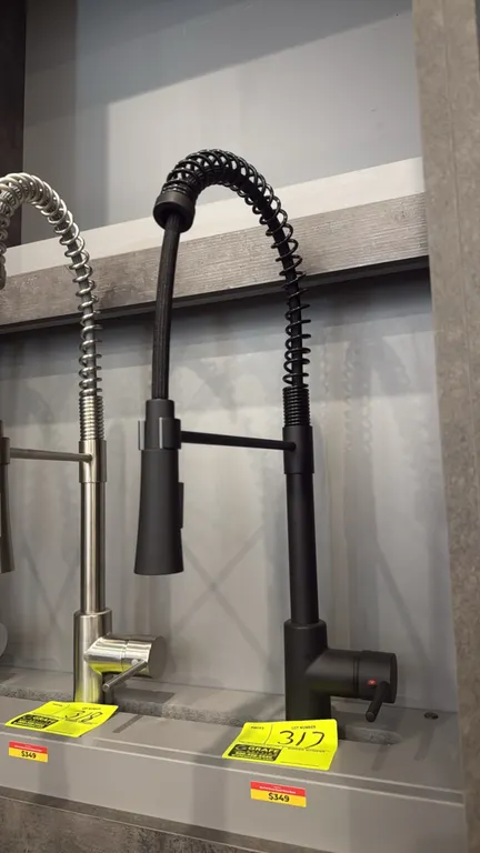 Nile pull-down kitchen faucet. Features a matte black finish, commercial-style open coil spring spout, single-handle temperature and flow control, and