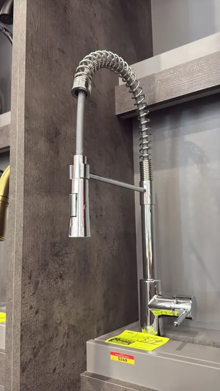Nile FA.SAN.01.009 pull-down kitchen faucet. Features a chrome finish, high-arc open-coil spring spout, pull-down spray head, and single-lever control