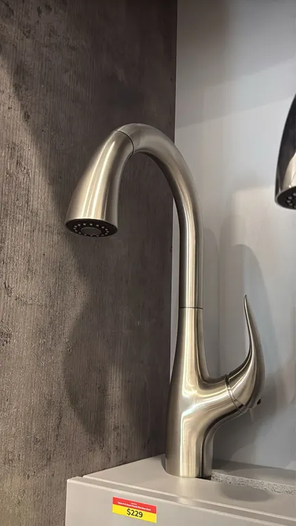 Yukon FA.SAN.01.001 single-handle pull-down kitchen faucet. Features a stainless steel finish, high-arc gooseneck spout, pull-down spray wand, and sin