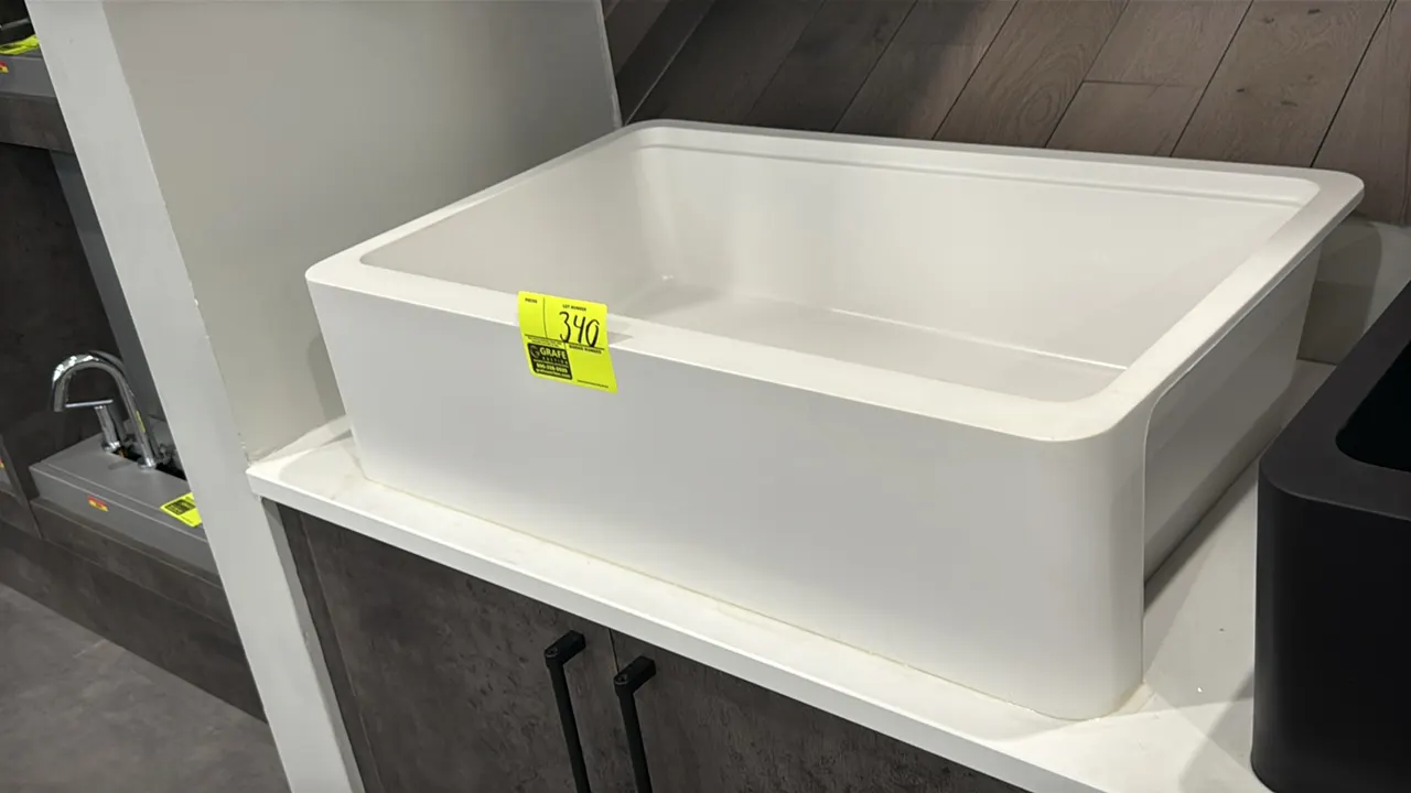Zinnia 33" single-bowl composite farmhouse apron front sink. Features durable composite construction in white with an apron front and includes a stain