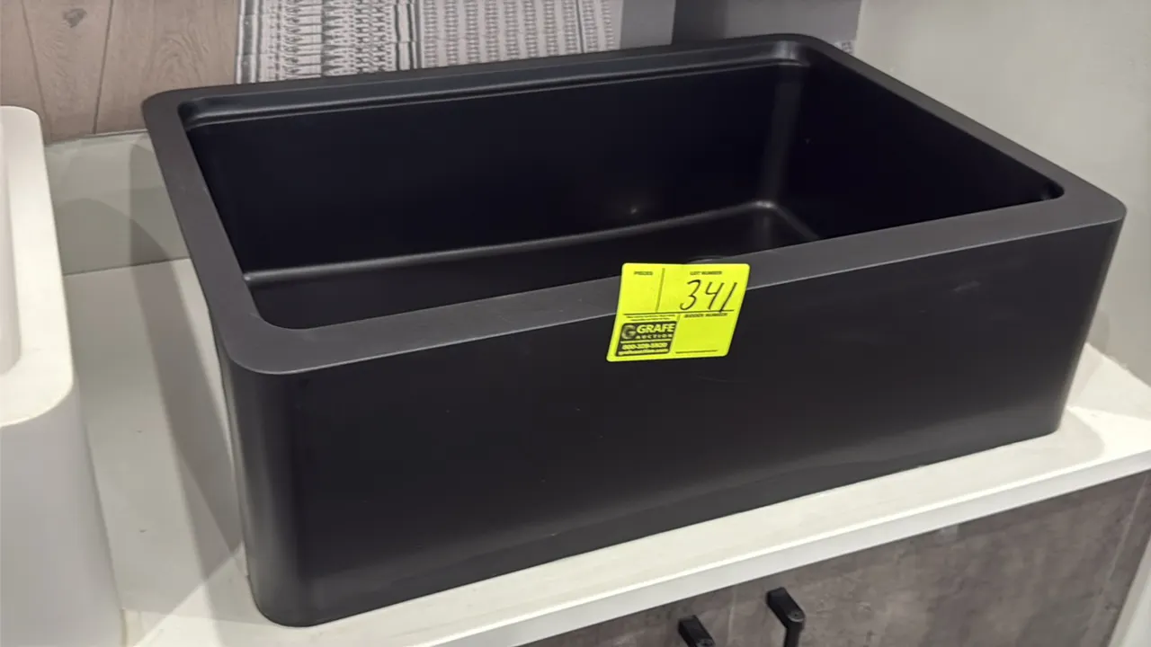 Zinnia 30" single-bowl composite farmhouse apron-front sink. Features black composite construction. Includes stainless steel drain basket strainer.