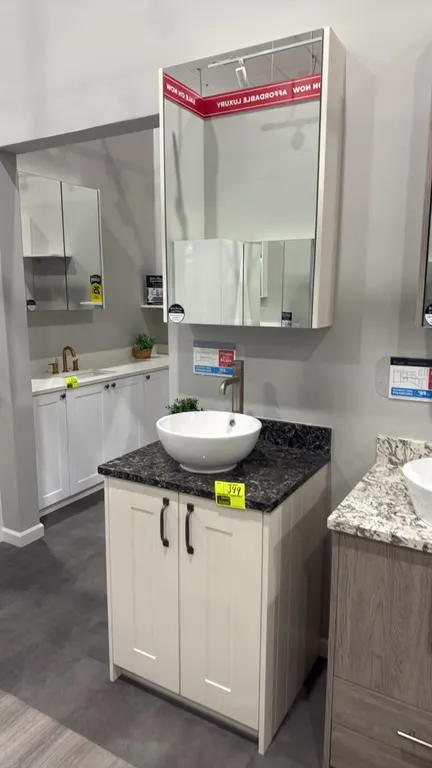 Infinity Shaker Classic cream matte vanity cabinet set. Features 2-door base cabinet, dark patterned countertop with backsplash, round white vessel si