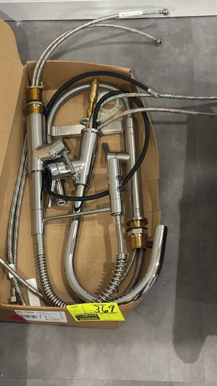Assorted pull-out kitchen faucets. Features single-handle operation, pull-down and spring-neck sprayers, and flexible braided water supply lines. Incl