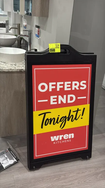 Black polyethylene A-frame sign stands. Features a folding design, molded top carry handle, recessed sign area, and integrated base wheels for mobilit