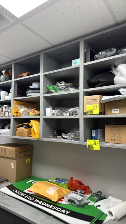 Assorted cabinet contents. Lot includes countertop and cabinetry sample blocks, acrylic sign holders and stands, desk phones, HP toner cartridges, cer