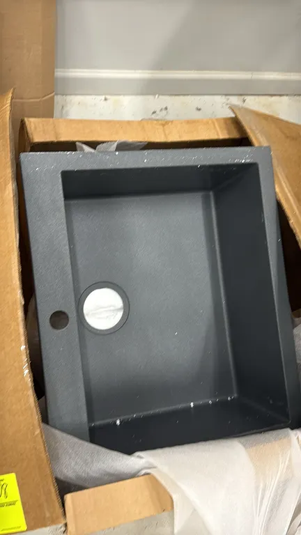 Single-bowl composite sink. Features dark gray composite construction, single-basin design, and a pre-drilled faucet hole. 21"W. In original packaging