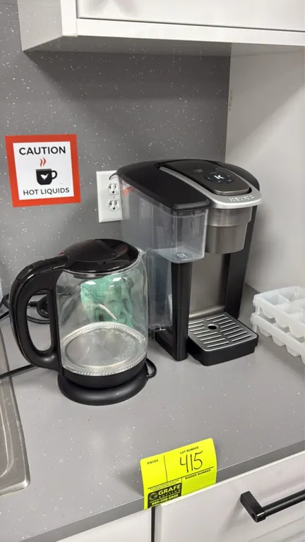 Assorted breakroom appliances. Includes an Avanti microwave with digital controls, countertop toaster oven, Keurig single-serve coffee brewer, and cor