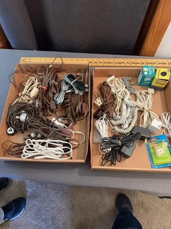 Assorted Electrical Cords Plugs Adapters and Bottl
