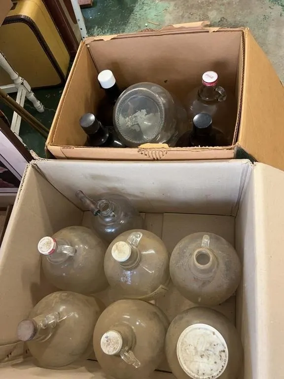 Assorted Clear and Amber Glass One Gallon Jugs and