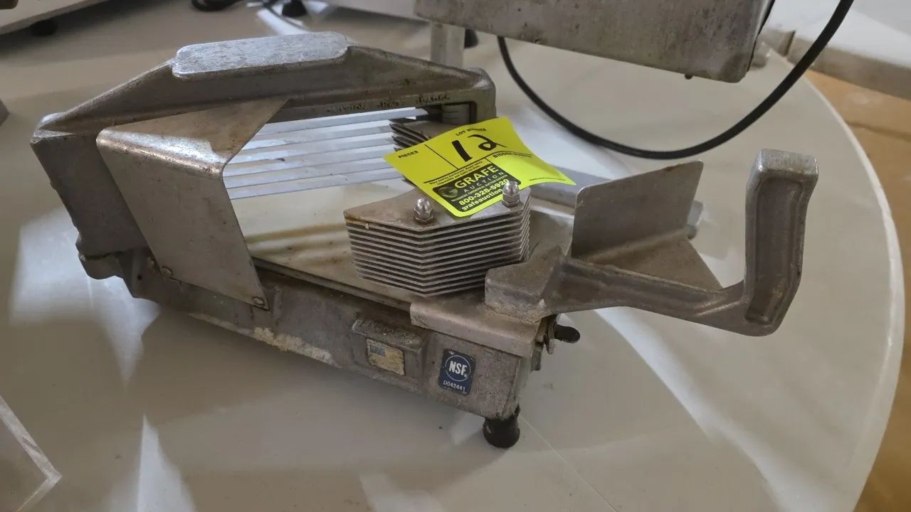Nemco manual horizontal slicer. Features cast aluminum construction, multi-blade assembly, manual pusher handle, poly slide board, and rubber feet. NS