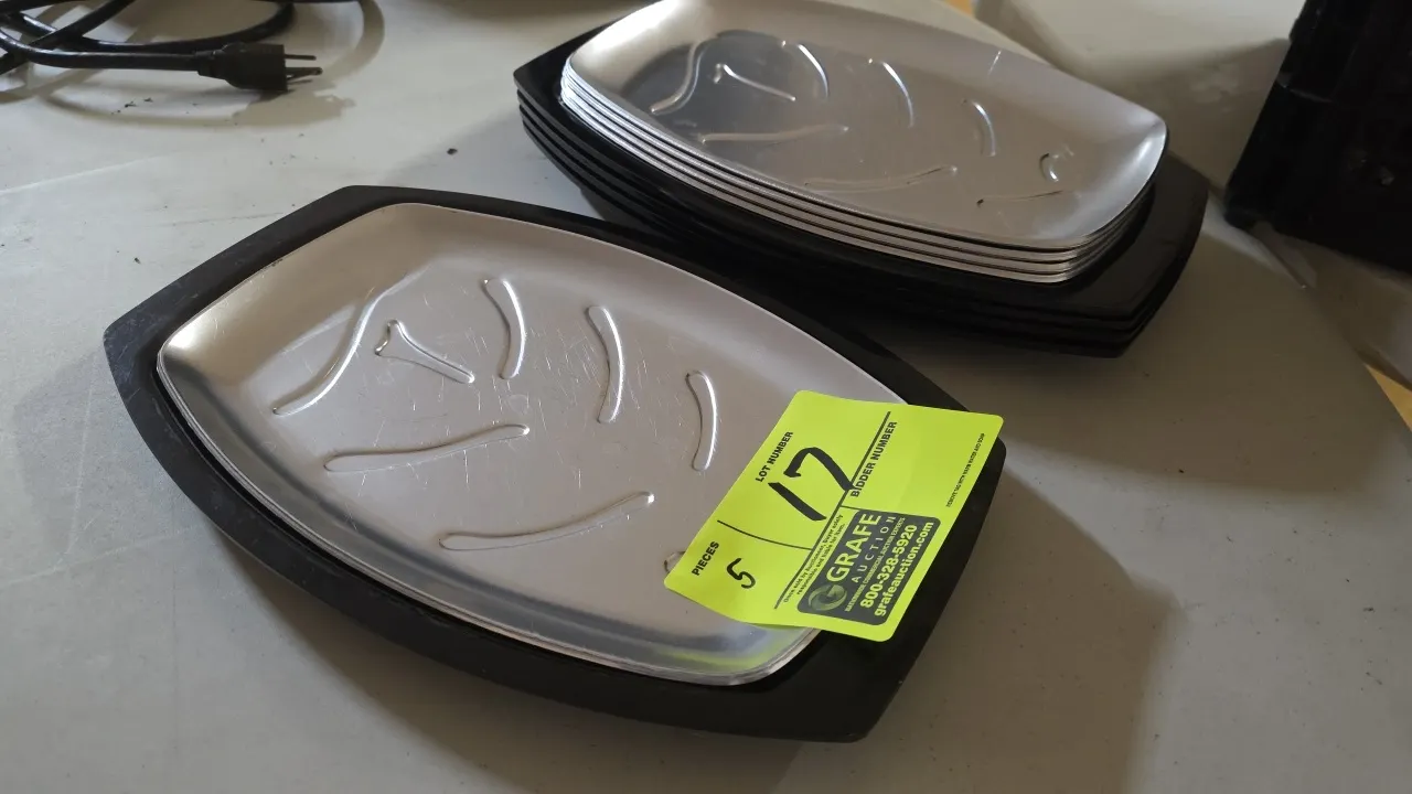 Nordic Ware No. 52 sizzler server steak platters. Includes (5) aluminum sizzler platters and matching black underliner holders. Features embossed grea