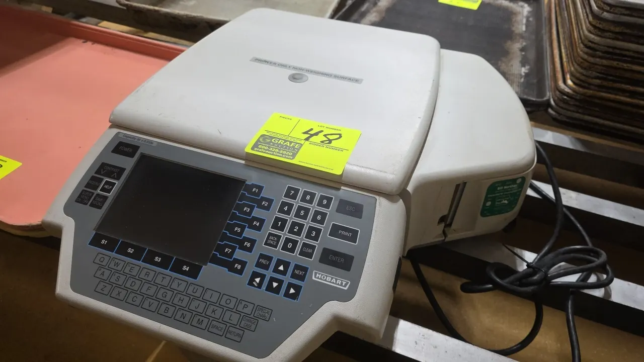 Hobart Quantum-P label printer. Features an integrated display screen, alphanumeric keypad, navigation keys, and thermal label dispenser. Marked non-w