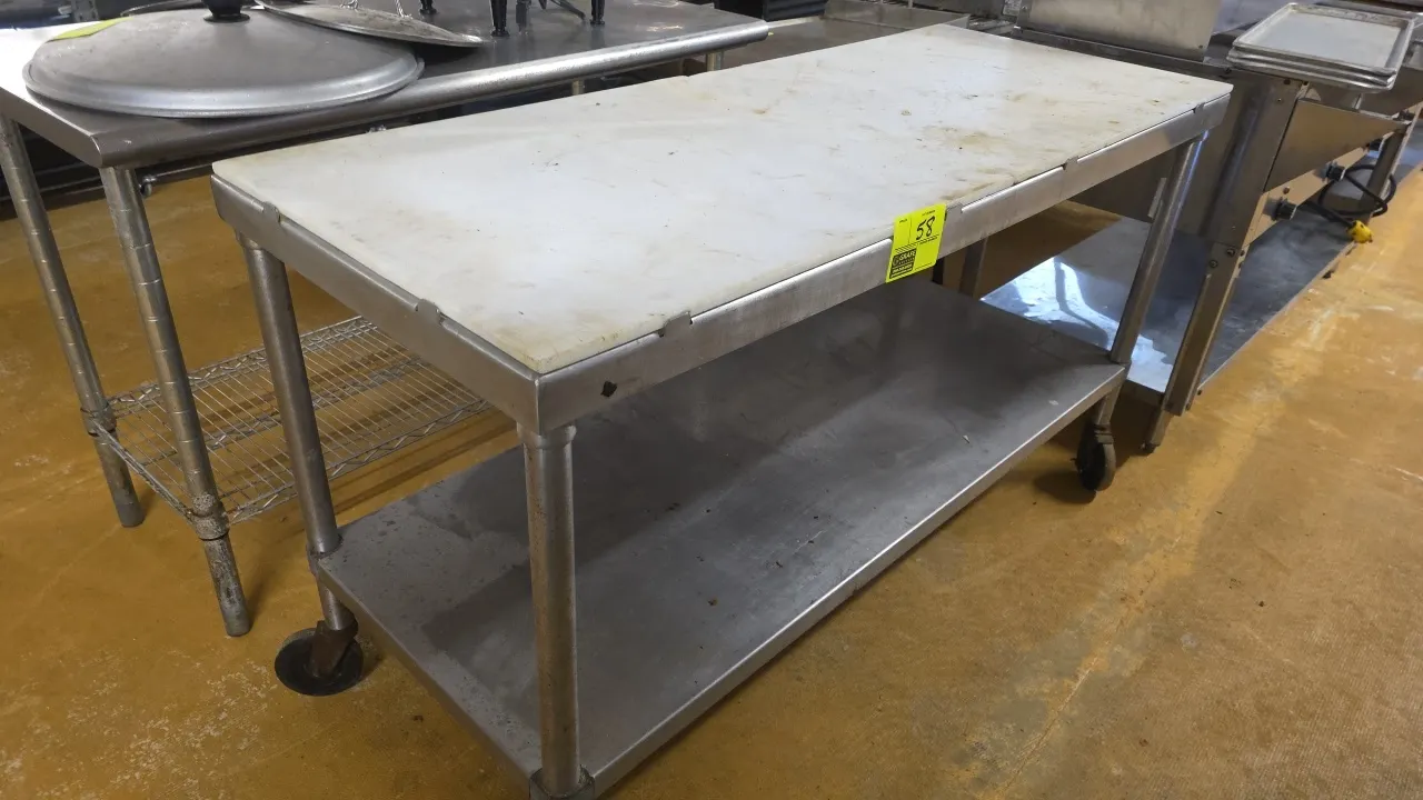 Stainless steel poly top portable work table. Features poly cutting board top and stainless steel undershelf. 60"L x 24"W. Mounted on casters.