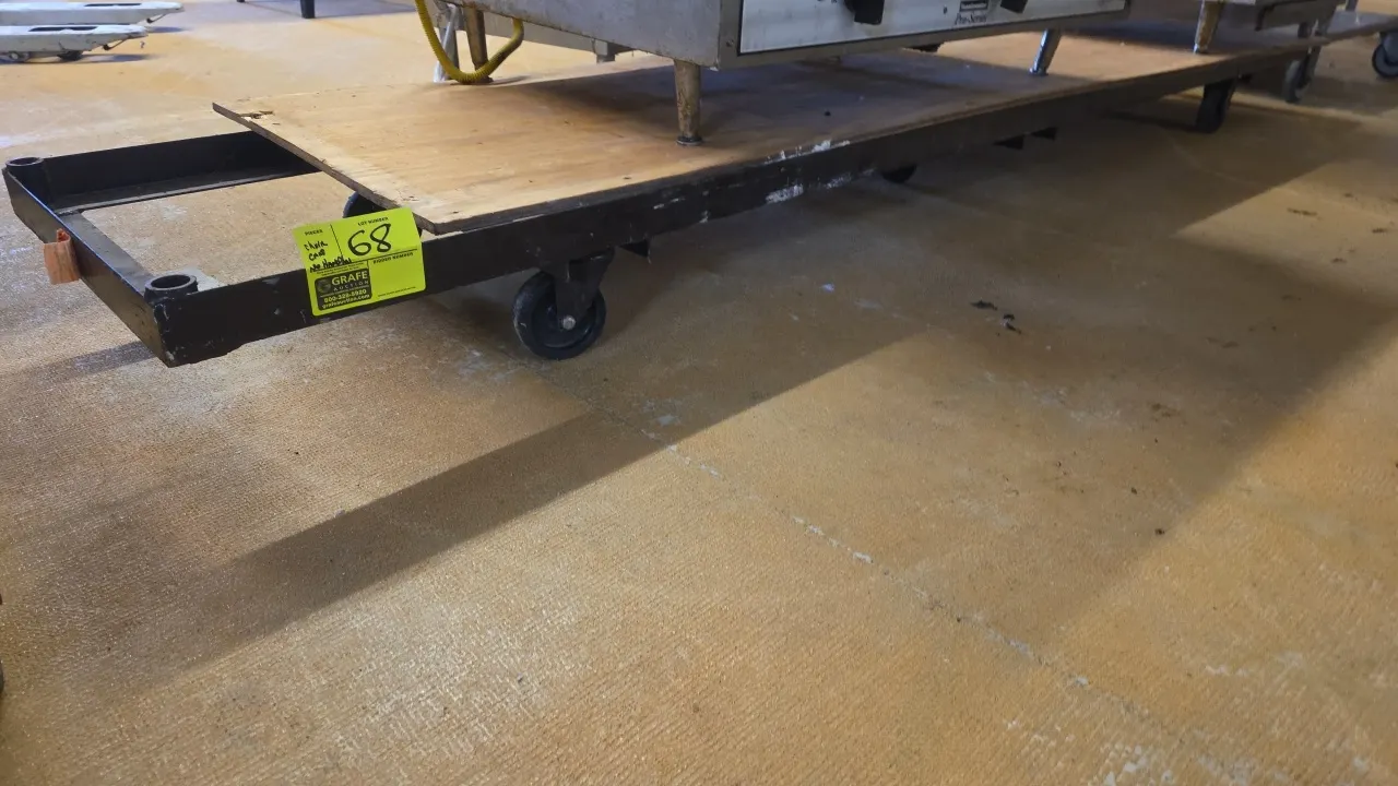 Metal chair cart. Features a steel frame with a wood deck. 105"L x 19"W. Mounted on casters. Note: Handles and contents are not included.