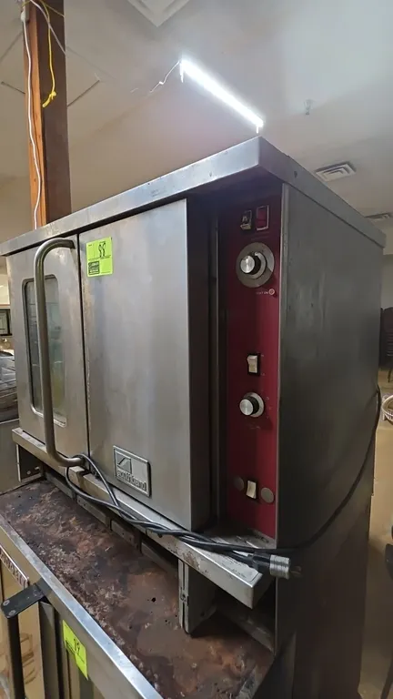 Southbend commercial gas convection oven. Features stainless steel construction, left door with glass viewing window, solid right door, manual tempera