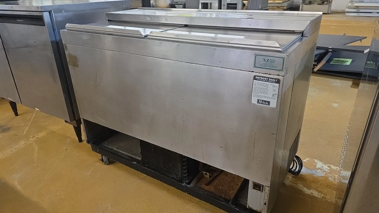 Perlick 8365A UL top-loading glass chiller. Features stainless steel construction, two sliding top lids, wire interior rack, and floor matting. Self-c