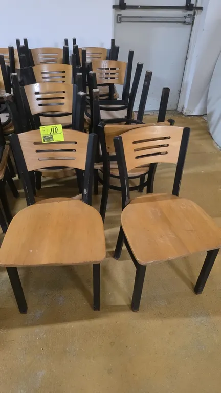 Metal frame restaurant dining chairs. Features black metal frames, natural finish wood seats, and curved wood backrests with horizontal slat cutouts.