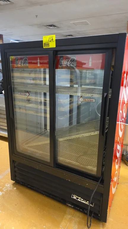 True GDM-33CPT-54 self-contained pass-through 2-door refrigerated merchandiser. Features sliding glass doors, adjustable wire shelving, and Coca-Cola