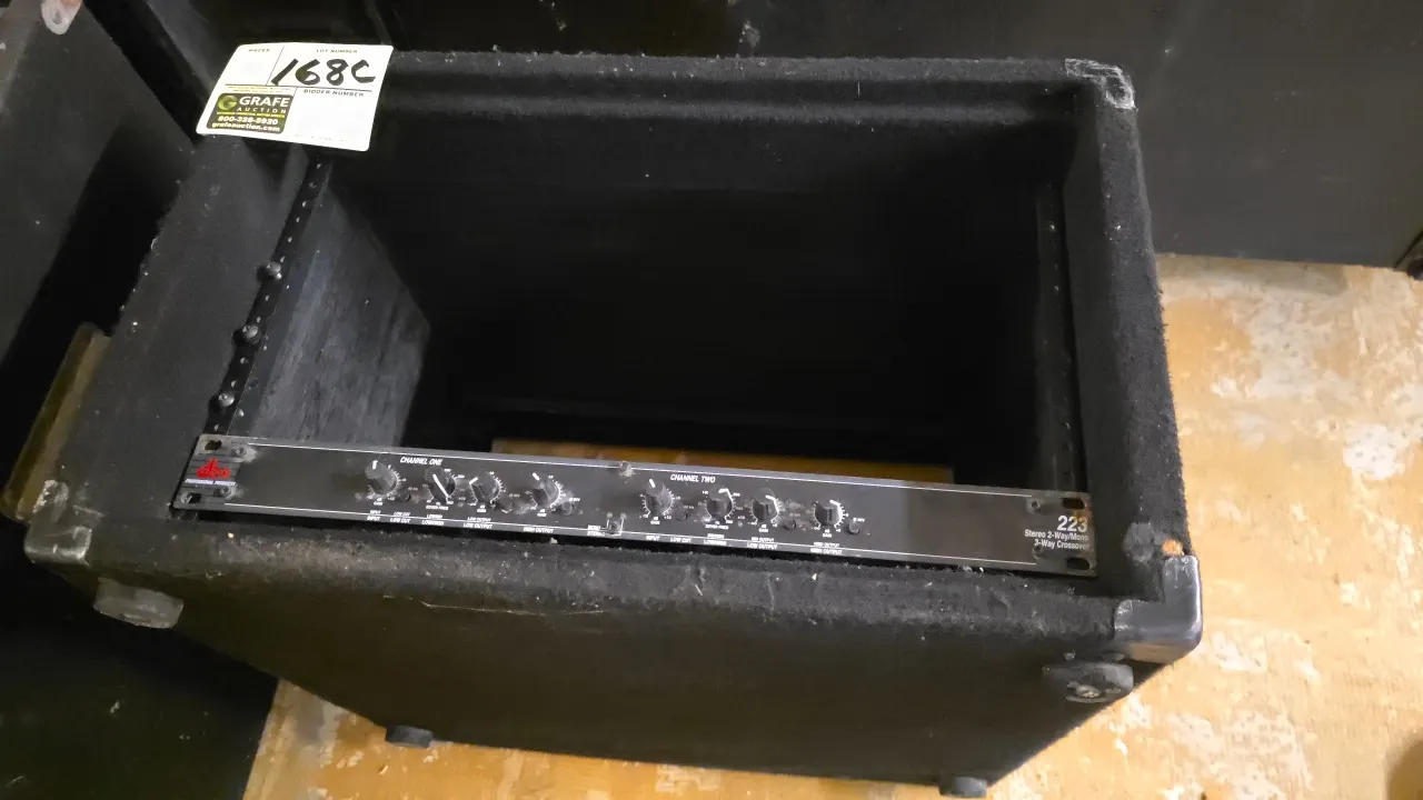dbx 223 stereo 2-way/mono 3-way crossover. Features dual-channel frequency controls and low/high output adjustments. Includes black carpeted equipment