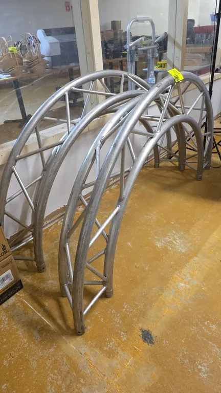 Aluminum curved lighting trusses. Features welded triangular 3-chord construction with diagonal cross-bracing and tubular pin connection ends. Include
