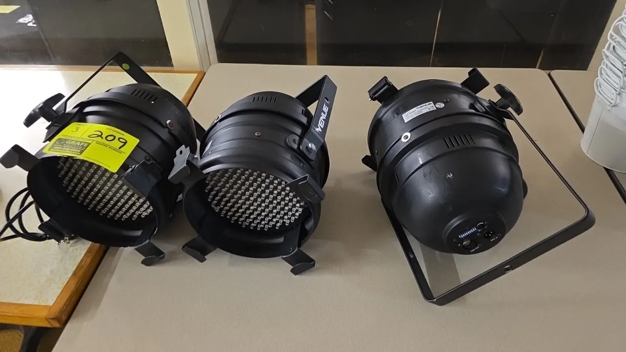 Venue LED PAR64 stage lighting fixtures. Features RGB color mixing LED arrays, gel frame clips, rear DMX in/out ports, and configuration switches. Ele