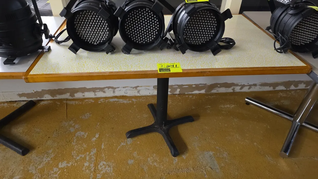 Laminated dining tables. Features patterned laminate tops with wood edge trim. 48" x 30". Mounted on black metal X-style pedestal bases. Contents not