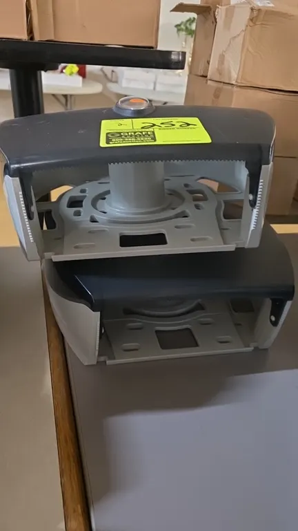 Georgia-Pacific bath tissue dispensers. Features translucent smoke plastic covers, center inspection windows, serrated tear bars, and molded plastic w