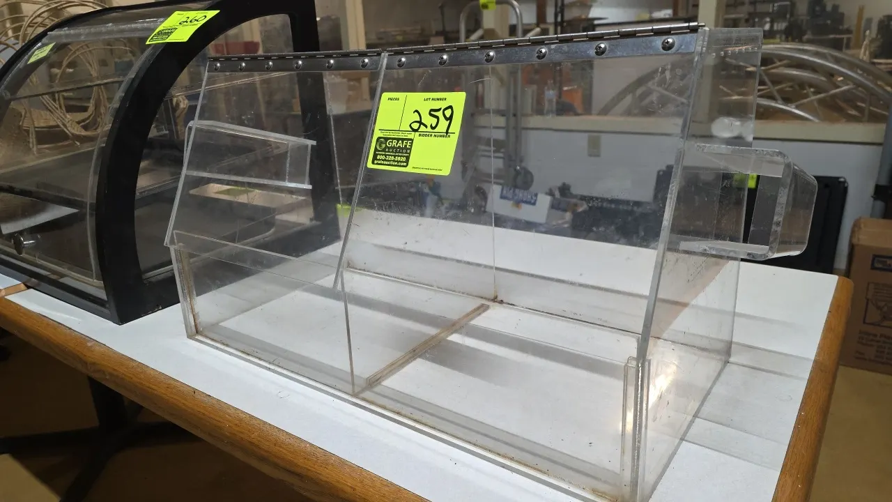 Poly countertop bulk display bin. Features clear construction, 2-compartment divided design, dual hinged flip-up lids, and side-mounted scoop/tong hol
