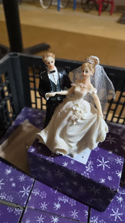 Wedding accessories lot. Includes (20) vintage-style bride and groom figurines in individual boxes and (1) set of fairytale castle wedding toasting ch