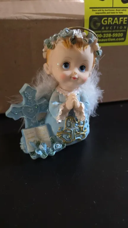 Bona Idea PY244B praying angel figurines with cross, 12-piece set. Features blue robes, gold-tone accents, floral headbands, and faux feather wings. 4