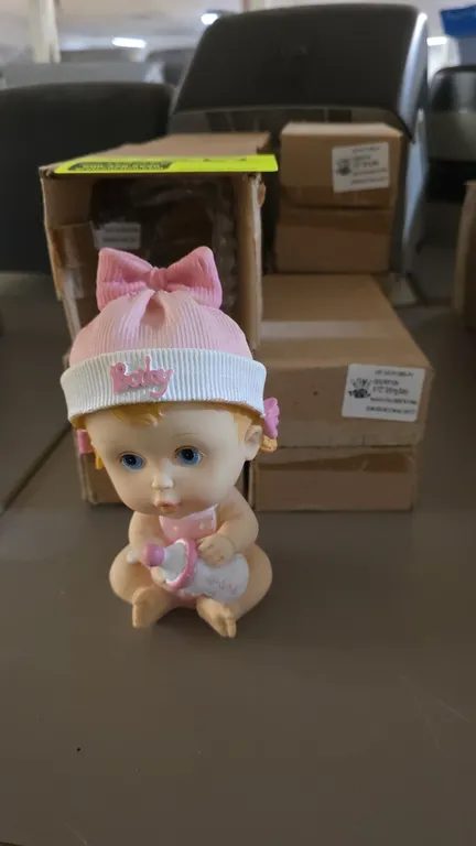 Bona Idea PY198G-PK sitting baby figurines. 7-piece set. Features seated baby girl figures wearing pink knit-style bonnets with 'Baby' text and matchi