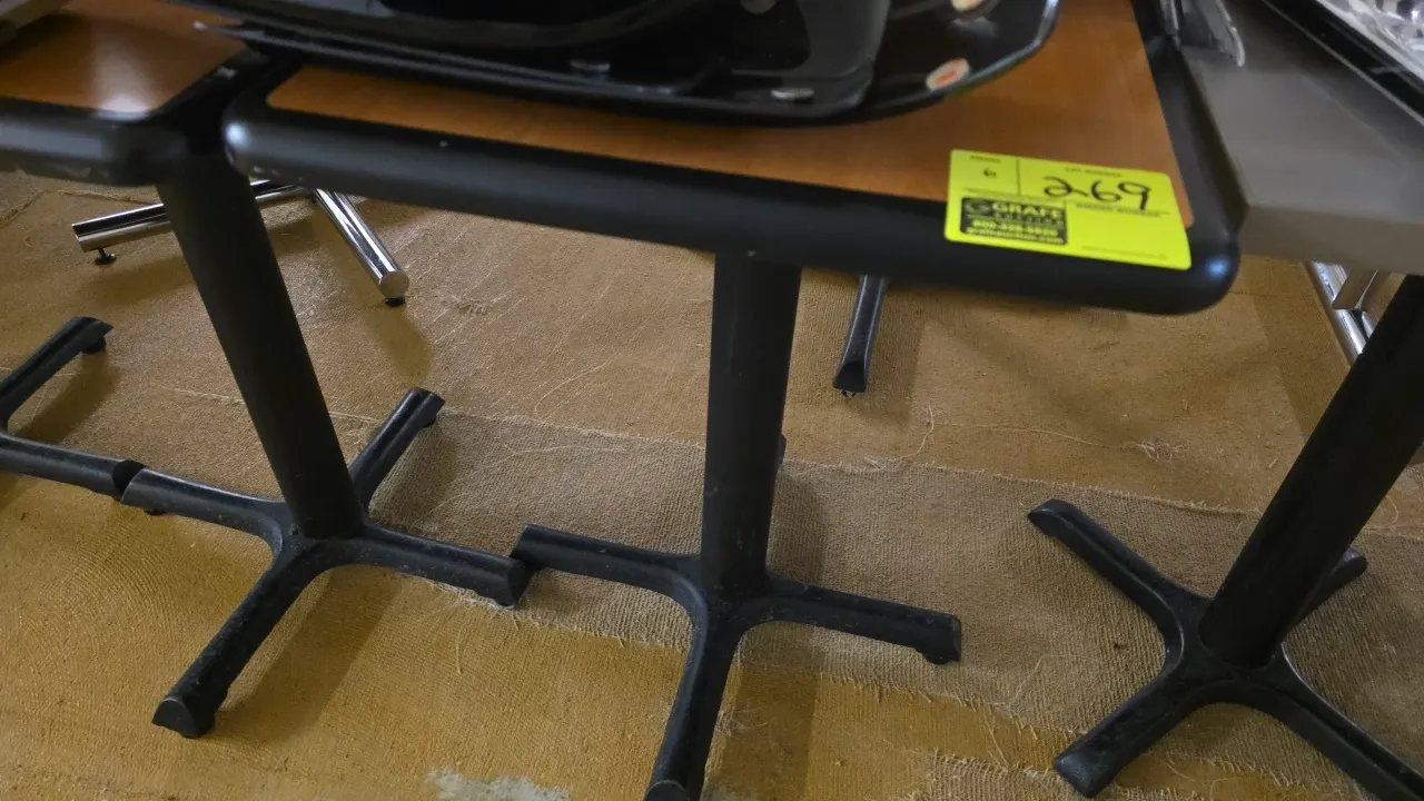 Dining tables. Features woodgrain laminate tops with black protective edging. Mounted on black metal X-style pedestal bases. 20" x 24". Contents not i