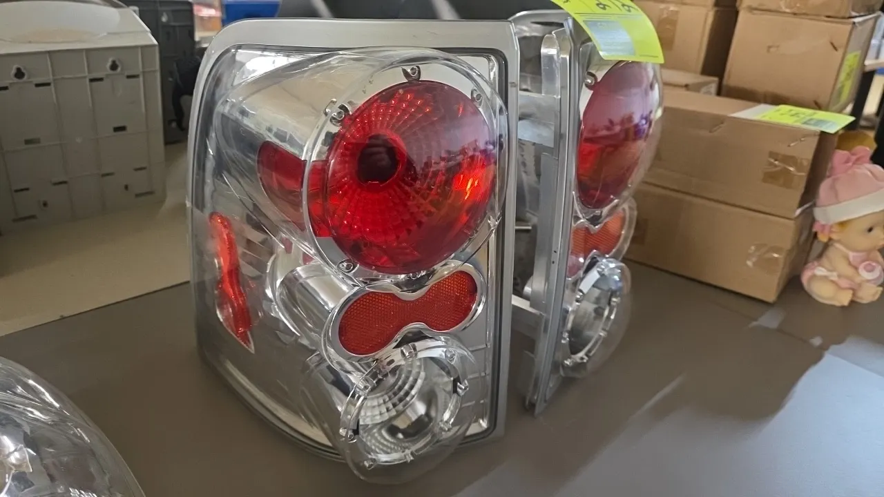 Ford Explorer (2002-2004) aftermarket tail light assembly set. Features Euro-style clear lenses, red and clear internal reflectors, and chrome housing