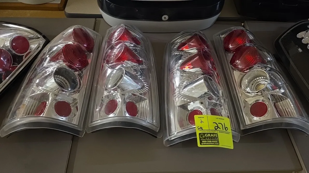 GM Silverado style tail light assemblies. Features clear outer lenses, chrome interior housings, and red internal lens sections. Designed for a 3-bulb