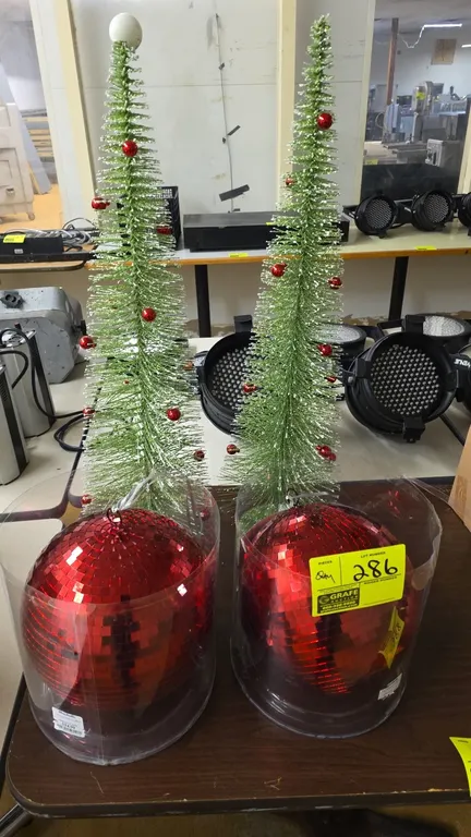 Assorted holiday decorations lot. Includes (2) green tabletop bottle brush Christmas trees decorated with miniature red ball ornaments, and (2) red mi