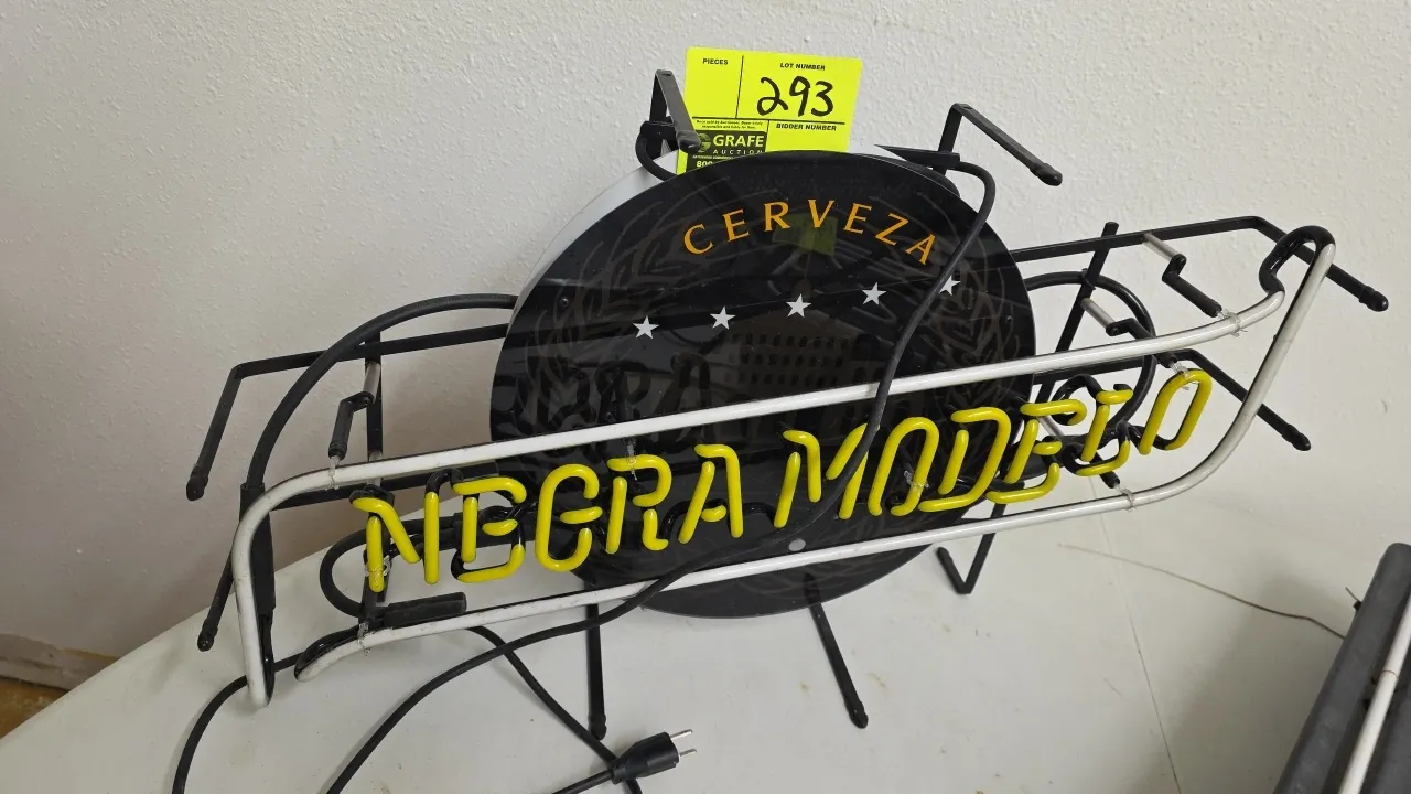 Neon Tech Negra Modelo beer neon sign. Features yellow 'NEGRA MODELO' and white border neon tubing with a central 'Cerveza' graphic shield. Mounted on