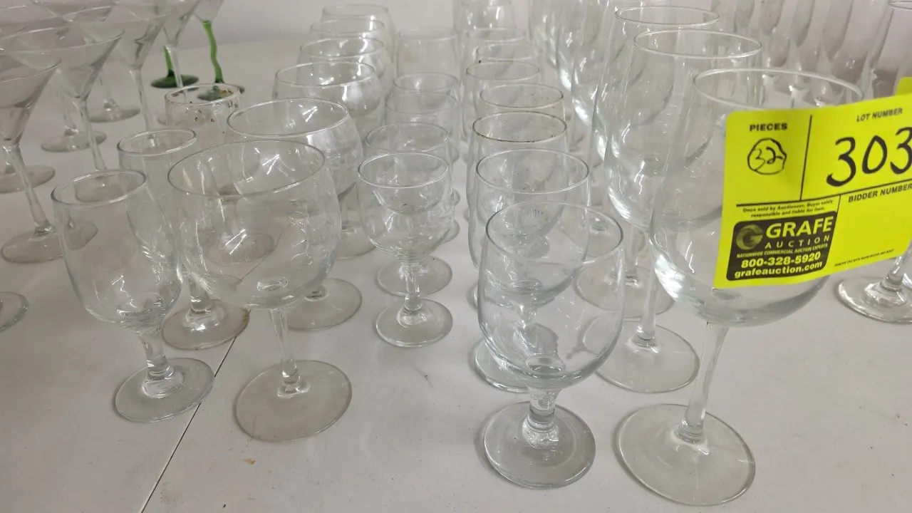 Assorted wine glasses. Includes (32) stemmed wine glasses in assorted sizes and styles. Clear glass construction.